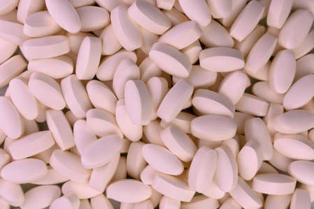 Background from collagen capsules. Supplement for youth and health.