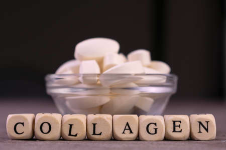 Collagen tablets and the inscription collagen on a dark background.
