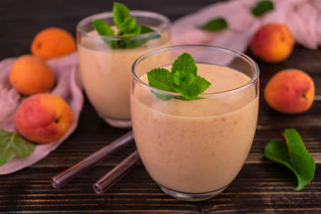 Smoothies from fresh apricots on a dark background.Selective focus.の写真素材