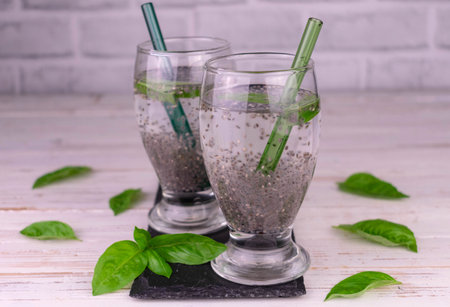 Two glasses of water with basil and chia seeds. Drink for weight loss.の写真素材