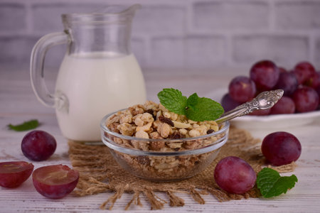 Granola with raisins and milk on a white background.Healthy breakfast.