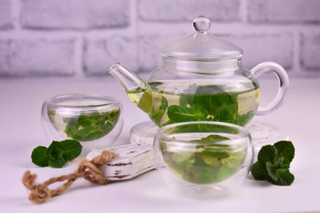 Mint tea with fresh mint leaves in a glass teapot.の写真素材