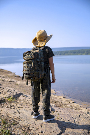 Man Traveler with photo camera and backpack hiking outdoor Travel Lifestyle and Adventure concept.の写真素材