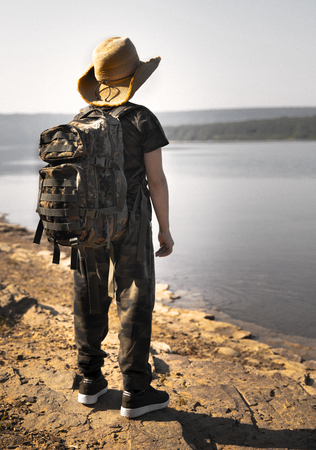 Man Traveler with photo camera and backpack hiking outdoor Travel Lifestyle and Adventure concept.の写真素材