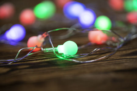 Christmas lights on dark blue background with copy space. Decorative garlandの写真素材