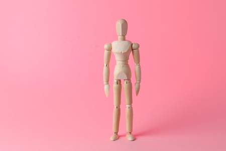Wooden mannequin. Wooden man. Wooden mannequin on a black background.