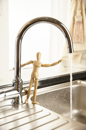Faucet with flowing water. Concept Save Energy Water, Water Drop from Tap.の写真素材