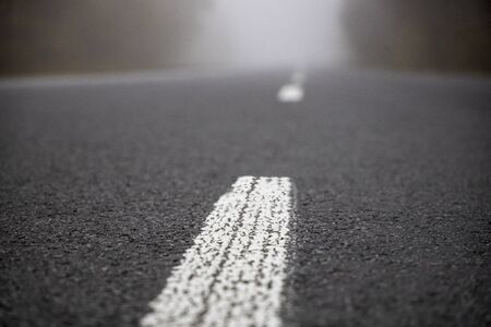 Car on the road in the fog. Autumn landscape.の写真素材