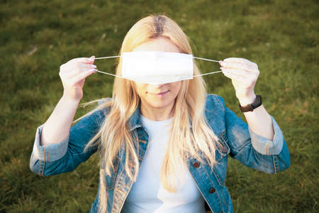 Wrong way to wear a mask - woman wearing mask to cover her eyes.