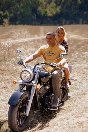 Couple on a motorcycle in the countryside. Man and woman on a motorcycle.の写真素材