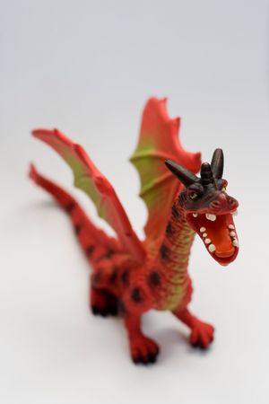 little red dragon toy against white backgroundの写真素材