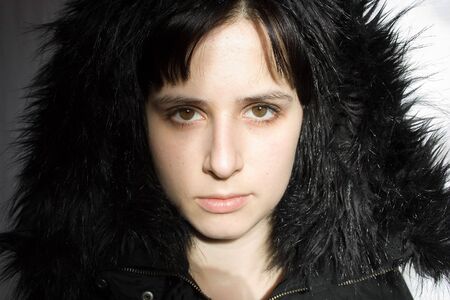 portrait of a girl partly in ahadow and lightの写真素材