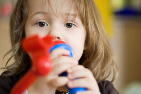 little girl singing with her toy microphoneの写真素材