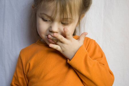 photo of little girl wearing orange shirtの写真素材