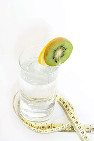 glass of water with kiwi isolated on whiteの写真素材