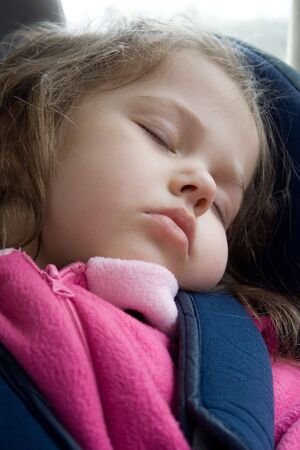 Portrait of little girl sleeping in the car