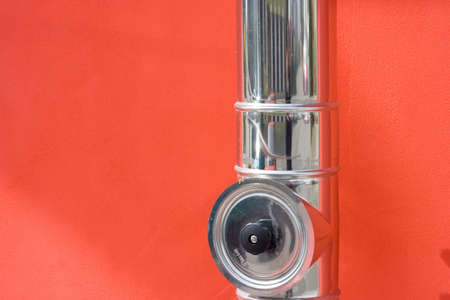 silver pipe against red wallの写真素材