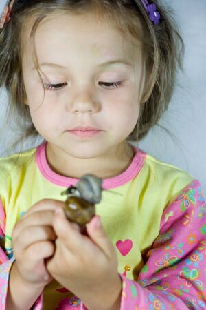 portrait of little girl with the snailの写真素材