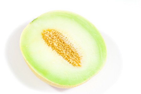 half of fresh melon isolated on whiteの写真素材