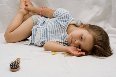 portrait of a little cute girl in striped dressの写真素材