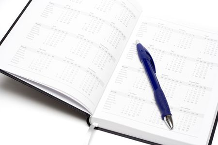 open calendar with blue pen isolated on whiteの写真素材