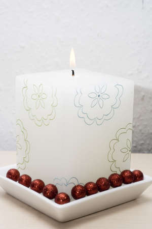 Beautiful candle with blue and green flowersの写真素材