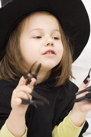 the little girl wearing witch halloween costume