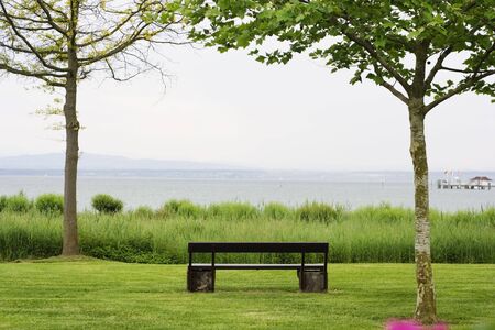 bench in the park with the view on the lakeの写真素材
