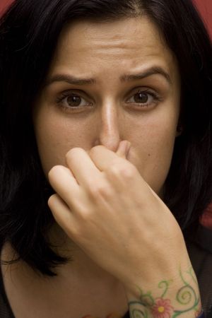portrait of a young woman with tattoo on her hand