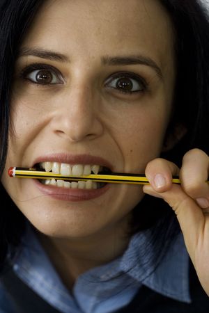 young depressed business woman biting a pencilの写真素材