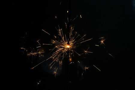 one christmas sparkler against the black background