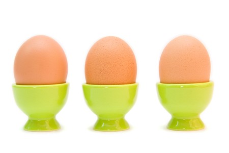 eggs in eggcups isolated on white. easterの写真素材