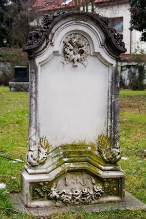 a blank tombstone covered with a moss