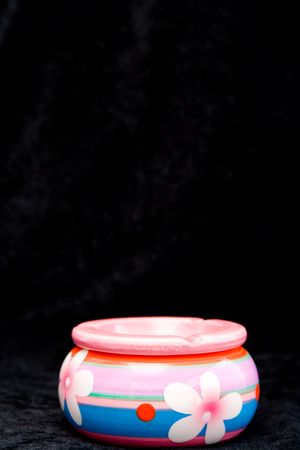 the colorful ashtray with flowers on blackの写真素材