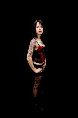 sexy brunette girl wearing corset isolated on blackの写真素材