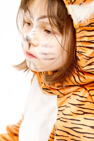 little girl wearing tiger costume isolated on whiteの写真素材