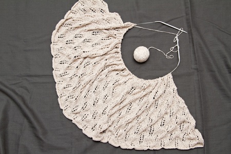 a beige knitted shawl with round needles 