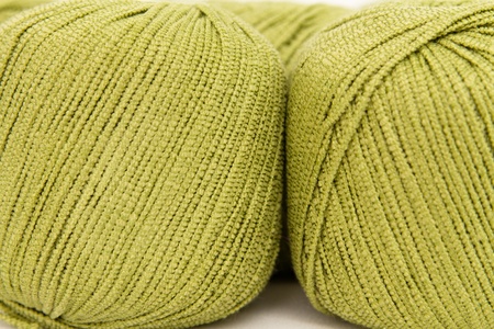 the green yarn skeins isolated on whiteの写真素材
