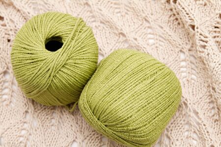 two green yarn skeins on the clothの写真素材