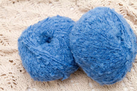 two blue yarn skeins on the clothの写真素材