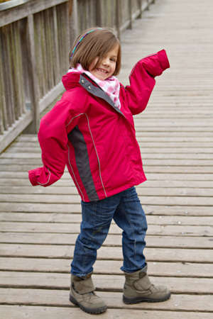 a little girl havin fun on a wooden bridgeの写真素材