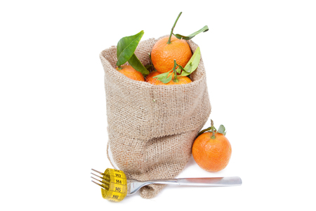 the mandarins in the sack isolated on whiteの写真素材