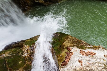 the water flowing down on the stone