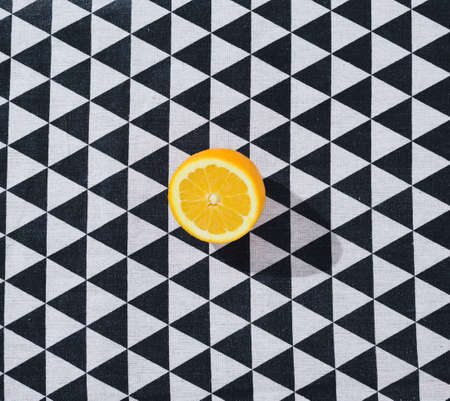 Fresh orange cut in half. Background black and white.の写真素材