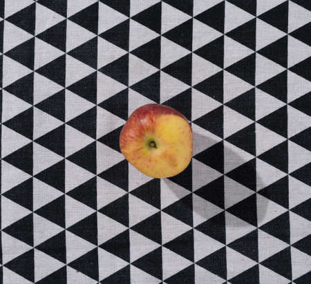 Red apple on a black and white background. Fresh fruit in a conceptual setting. Flat lay.の写真素材