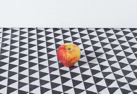 Red apple on a black and white background. Fresh fruit in a conceptual setting.の写真素材