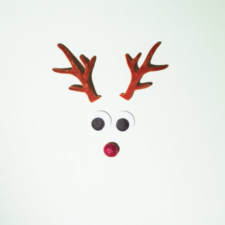 Reindeer horns placed on a white background. Winter idyll concept. New Year's set and red nose decoration.の写真素材