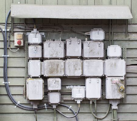 Several old box switches mounted on wall,
