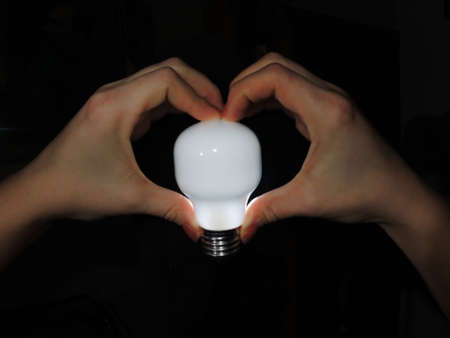 The bulb is ignited in a handsの写真素材