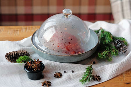 Meat under a glass cloche with vegetables, giving about the steam. Lunch time.